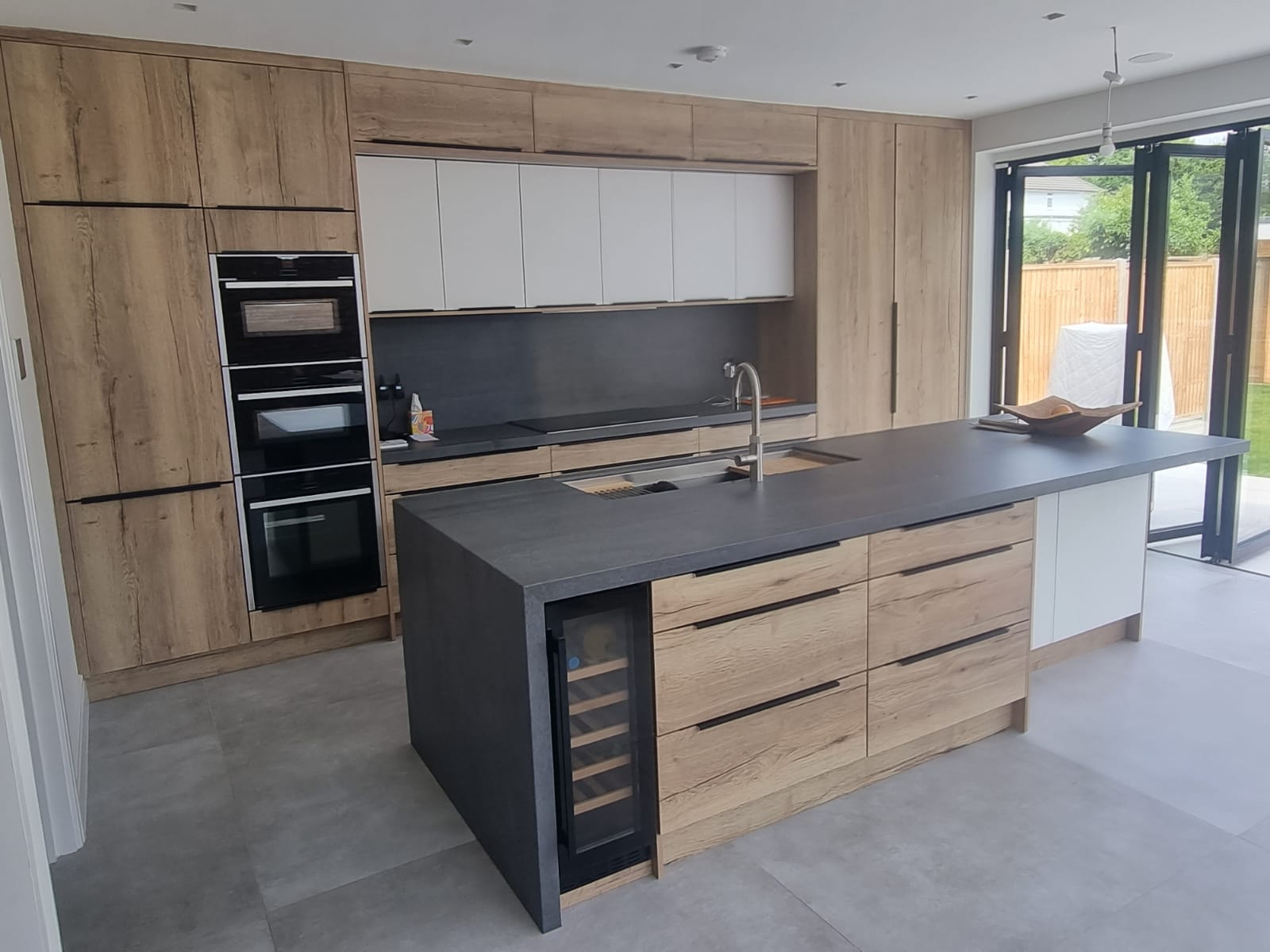 Bespoke kitchen in Mansfield with custom cabinetry, a statement island, and modern pendant lighting