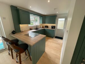 Small bespoke kitchen in light green and light floor. Giving a spacious feel